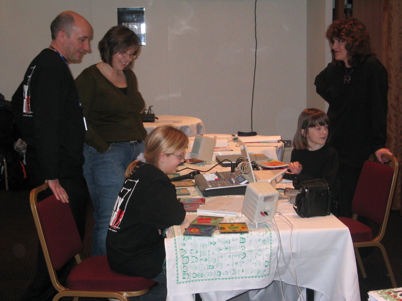 James Bloomfield and Lys look on as the children show their work