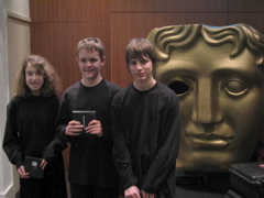 Stepping Stones pupils in front of BAFTA mask