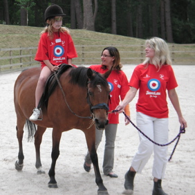 Horse riding in the menage, supported by Sandy and Sahar