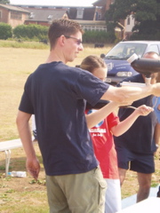 Jonathan supports the barrel of the gun as Amy fires