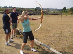 Sandy releases an arrow towards the target