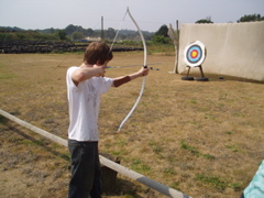 Dan pulls the bow back almost to his ears!