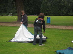Daniel and Dominic lay out the tent.