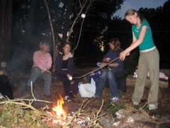 Amie cooking (burning?) a marshmellow.