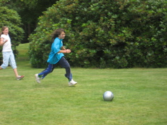 Lucy runs with the ball towards goal