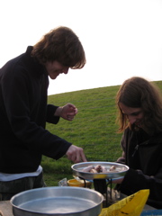 Dominic and Daniel fry the sausages using a pressure stove.