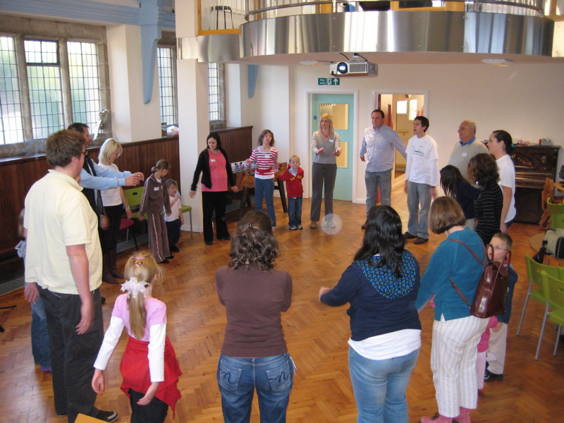 Children and parents "warm up" as the workshop begins
